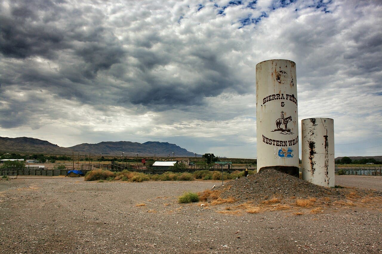 Roadside view of Truth or Consequences, New Mexico, with desert mountains in the background.
