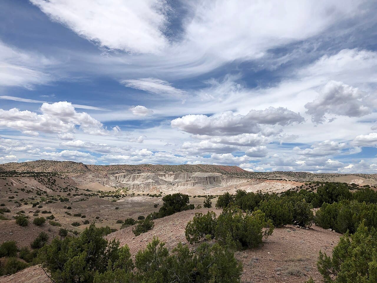 Wide desert view of the white sandstone cliffs and badlands of Plaza Blanca near Abiquiu, New Mexico.