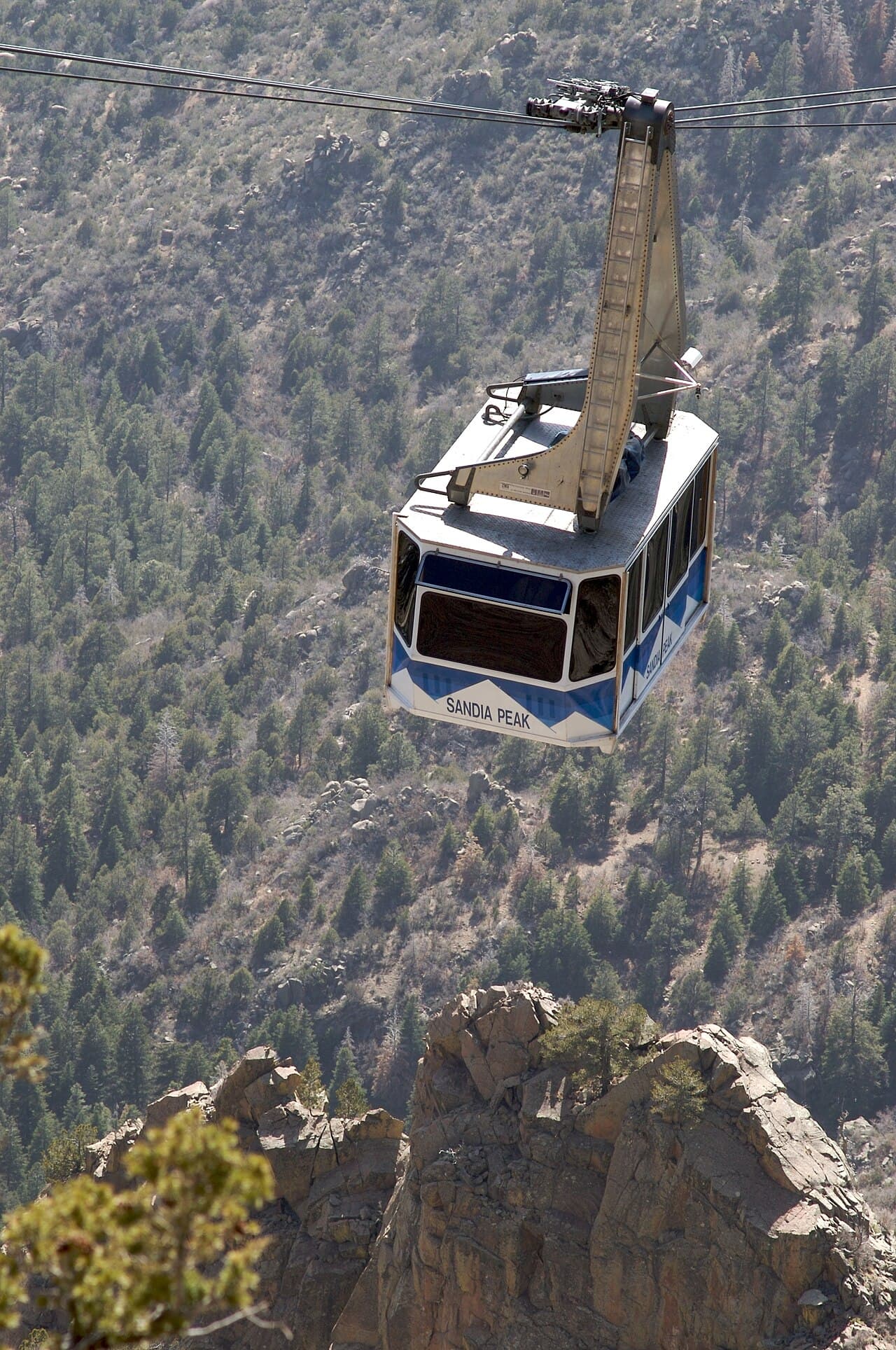 A Sandia Peak tramway car climbing above the foothills.