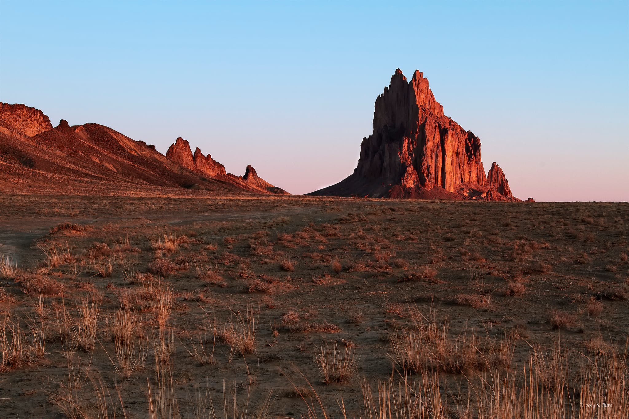 Early morning view of Shiprock volcanic plug rising from the Navajo Nation desert in San Juan County, New Mexico