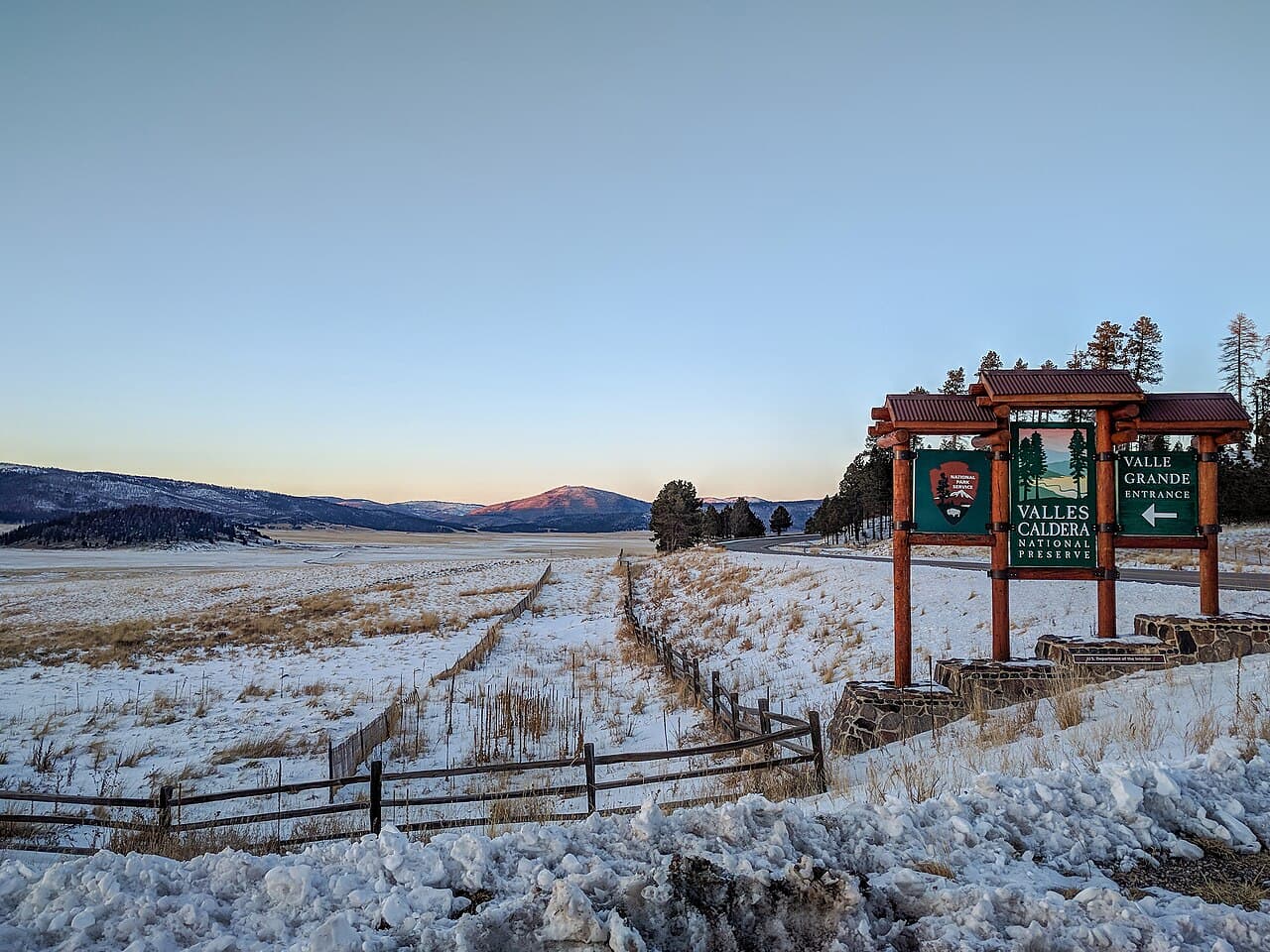 Wide grassy valley floor of the Valles Caldera, ringed by forested mountains, New Mexico.