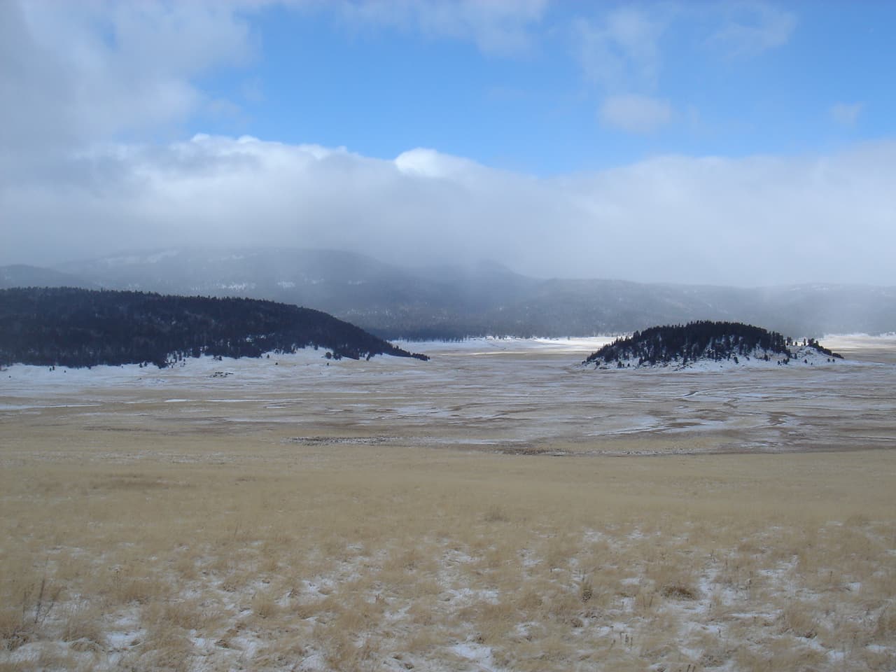 Valle Grande in winter at Valles Caldera National Preserve, with forested lava domes South Mountain and Cerro la Jara in the foreground